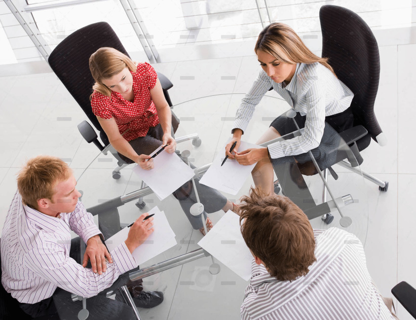 demo-attachment-458-four-businesspeople-in-a-boardroom-with-paperwork-PC4V8H4
